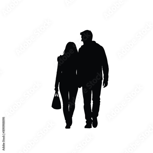 Silhouette of a romantic couple walking together with arm around shoulder