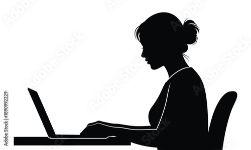 Silhouette of a woman typing on a laptop computer at a desk