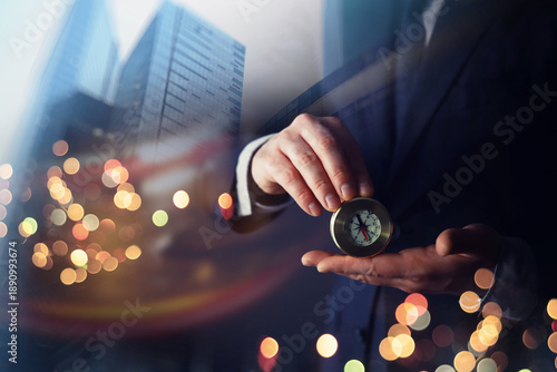 Man with black suit showing compass, double exposure, skyscraper, Concept business, finance saving and investment,on compass background