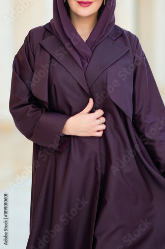 Qatar, Doha, 17.10.2022: Close-up of a woman in a purple abaya that emphasizes the layering of the fabric.
