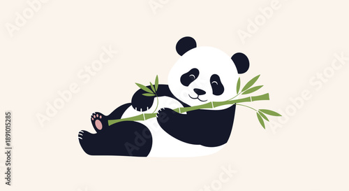 Adorable panda bear lies comfortably on its back while holding a green bamboo branch with leaves in its paws against a plain background.
