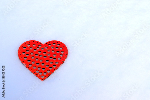 Valentines Day red heart in winter in snow. Red wooden heart, scene with love message.