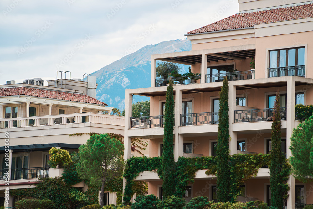 Fototapeta premium Modern apartment building with balconies and greenery