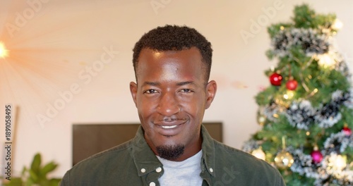Foto Smiling adult man wearing green overshirt and gray tee, facing camera at home, C