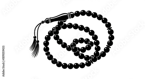 Black prayer beads with tassel and cylindrical charm on white background symbolizing spirituality and meditation