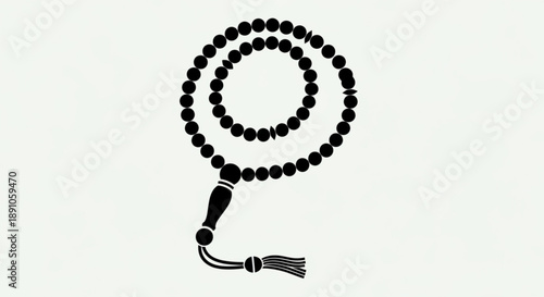 Black prayer beads with tassel on a light background symbolizing spirituality and mindfulness in a simple elegant design
