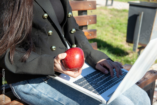 young girl with apple in the park. girl in the park.
