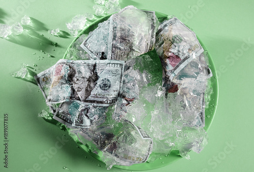 Dollar bills encased in melting jelly cake as a metaphor for inflation