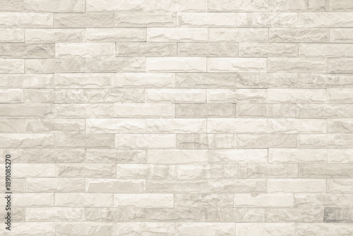 Cream and white brick wall texture background. Brickwork and stonework flooring interior rock old pattern clean concrete grid uneven bricks design stack. Background of old vintage brick wall.