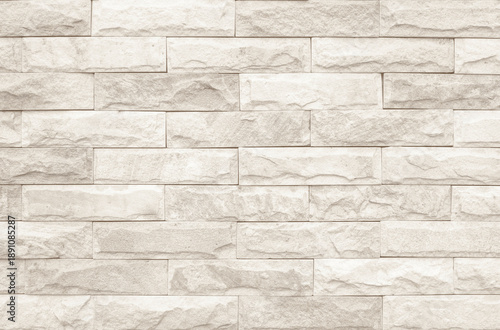 Cream and white brick wall texture background. Brickwork and stonework flooring interior rock old pattern clean concrete grid uneven bricks design stack. Background of old vintage brick wall.