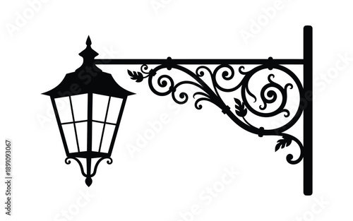 Black iron lantern wall bracket with ornate scrollwork and mounting post