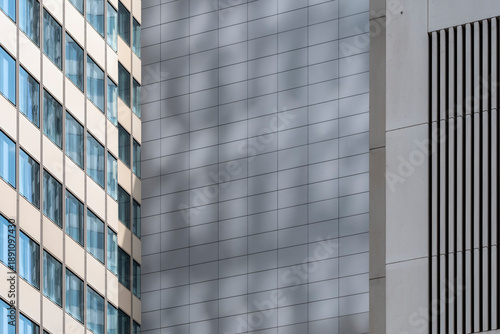 Modern architecture facade with windows metal grid and lines casting shadow geometry for abstract corporate highrise building exterior detail