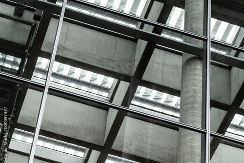 Industrial architecture structure with steel beams glass ceiling and grid geometry creating abstract interior pattern for modern engineering background