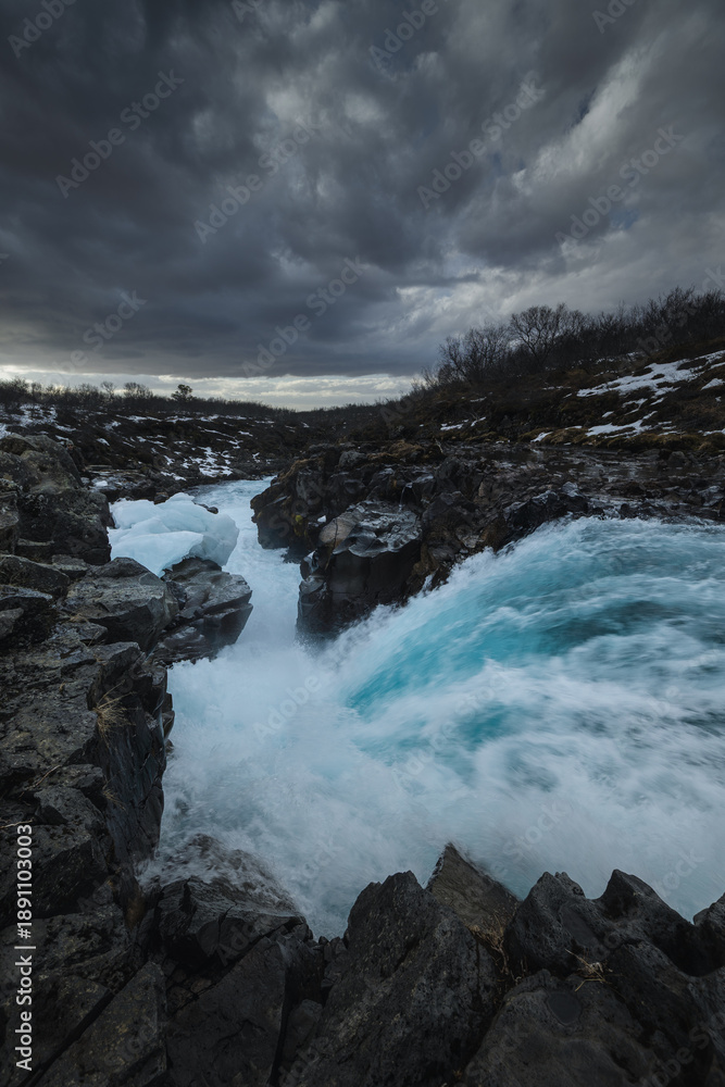 Fototapeta premium Bruarfoss waterfall in Iceland. Famous for its brilliant icy blue water swirling into a deep crevice. A hidden gem near the Golden Cir