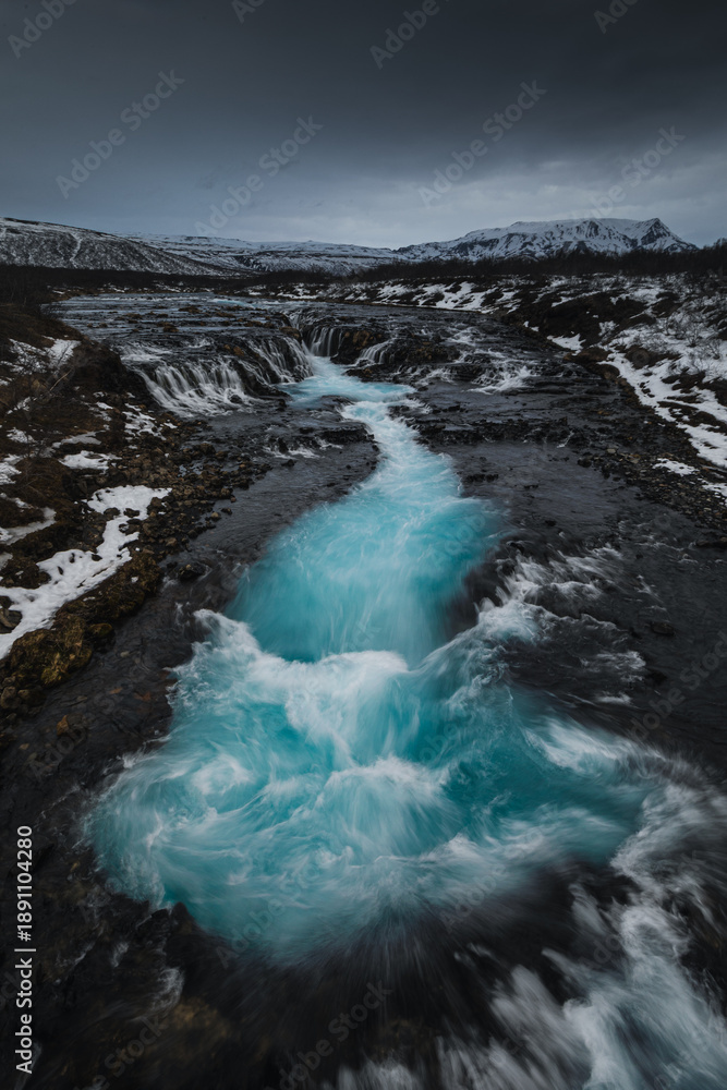 Obraz premium Bruarfoss waterfall in Iceland. Famous for its brilliant icy blue water swirling into a deep crevice. A hidden gem near the Golden Cir