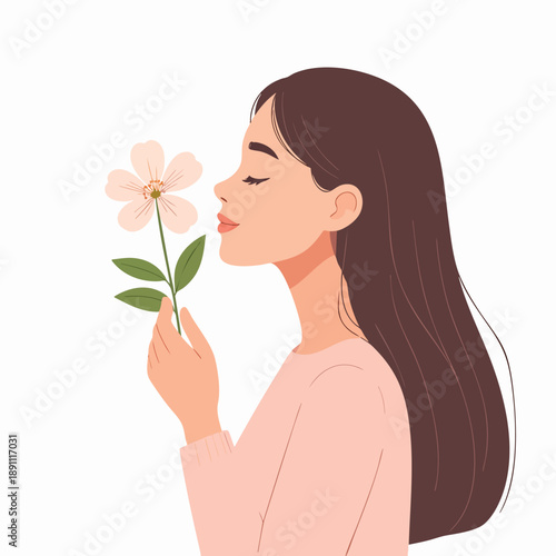 A young woman gently smells a delicate flower in a serene moment of solitude