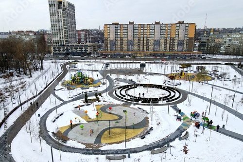Winter city snow landscape, Winter street park, tall buildings skyscrapers. Aerial view from drone.