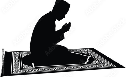 Person Praying on a Patterned Prayer Rug in Silhouette