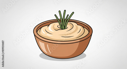 Creamy beige dip in a brown ceramic bowl garnished with green chives on a white background with soft shadow