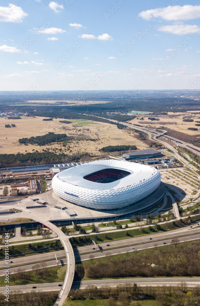 Obraz premium Munich, Germany - April 04, 2021: Drone flight over Football stadium Allianz Arena at sunny day