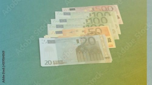 Animation of close up of euro bills against green and yellow gradient background