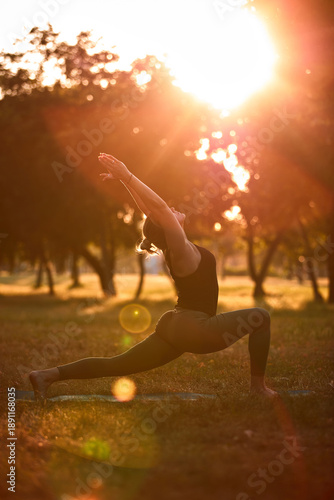 Wallpaper Mural Woman practicing yoga and stretching in the park on a hot sunny summertime day. Torontodigital.ca