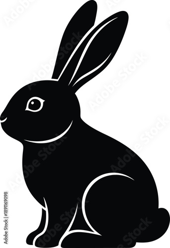 Black silhouette of a sitting rabbit or bunny, side view, vector icon or graphic design element