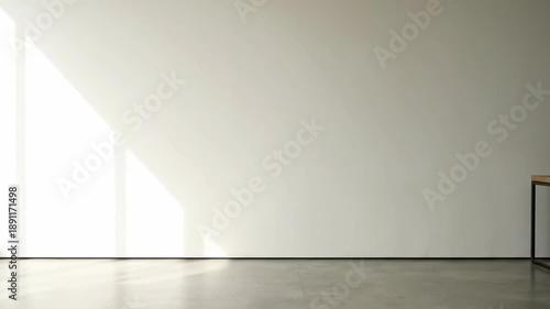 Minimalist white wall interior background with polished concrete floor, bright natural window light, and ample copy space for design mockups.