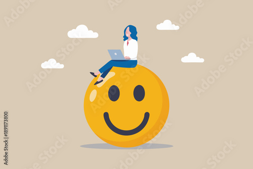 Woman working on laptop while sitting atop a giant smiling yellow face