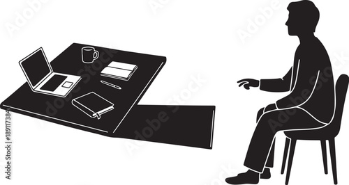 Man sitting at desk with laptop and office supplies