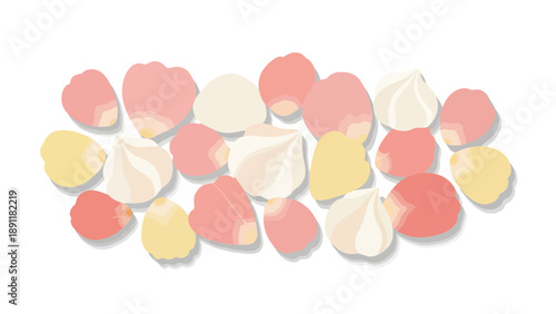 Sweet meringues and flower petals scattered on a white background