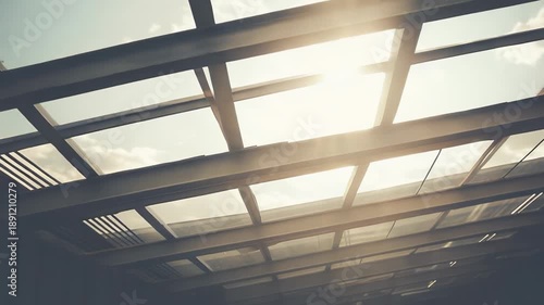 Glass skylight roof floods a modern building with warm daylight, showcasing geometric glass and beam framework, clean lines and a bright, inviting urban architectural view