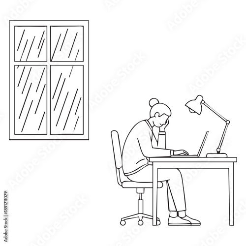 Person working at desk by window with rain outside