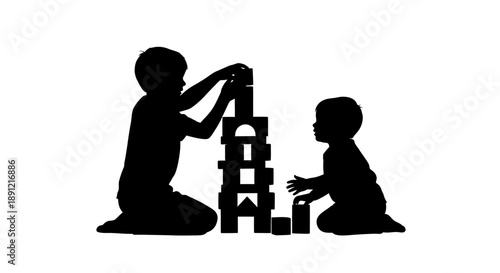 Two children playing with building blocks together in silhouette.