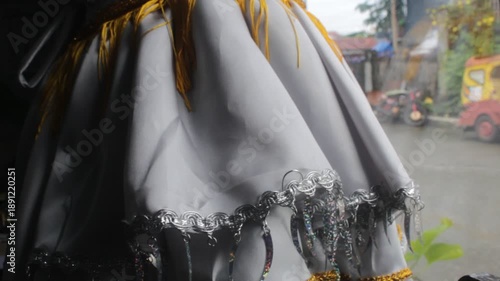 Cocktail Dress with a Strap Wearing by a Black Mannequin a Window Display on Boutique