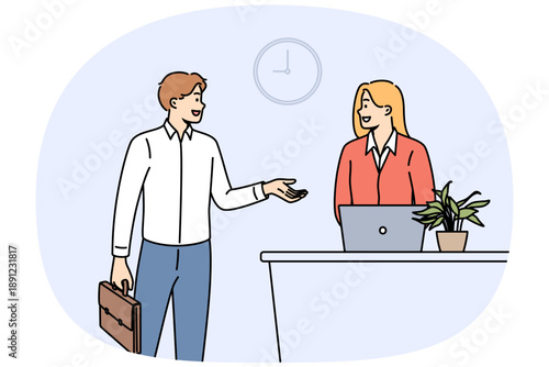 Man rents hotel room talking to administrator standing near reception desk with laptop. Successful businessman checks into hotel during corporate trip to attend professional seminar.