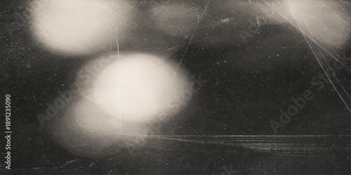 A moody texture of dark blue rain drops on a window merges with abstract white mist and storm clouds under a bright moon in the night sky