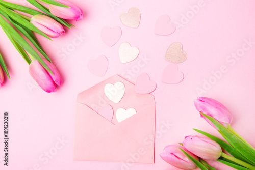 Beautiful and festive background with pink tulips and card for romantic valentines day celebration anniversary or birthday wishes in pink and white 