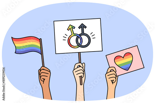 LGBT posters and flags in hands of people, with images of rainbow symbols and inscription love wins. LGBT community celebrates pride month and calls for fighting for rights of LGBTq individuals