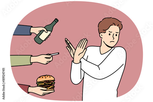 Man gives up bad habits, making forbidden gesture near hands with alcohol and cigarettes or fast food. Guy says stop bad habits to start healthy lifestyle and avoid loss of immunity