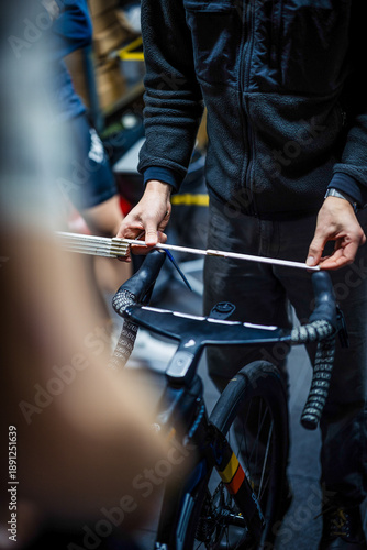 Mechanic measuring bicycle handlebars for bike fitting setup