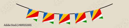 Seychelles national flag bunting banner hanging on a string for decoration during a festive patriotic holiday celebration.