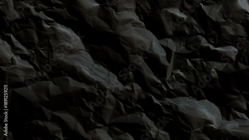 Crumpled black paper texture background closeup view