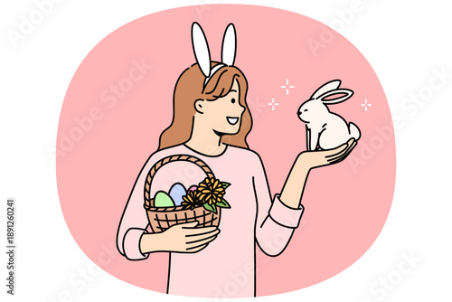 Teenage girl celebrating easter holds decorated eggs in basket and small rabbit, rejoicing at coming of spring. Schoolgirl is preparing for easter and bringing traditional gifts to friends from school