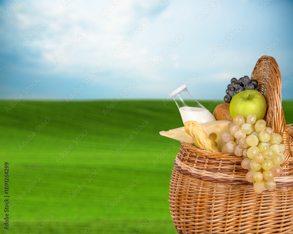 Obraz premium Beautiful cute picnic set on green grass in park