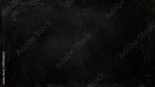 Dark scratched and distressed old black stone wall texture background