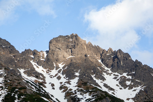 Wallpaper Mural Tatra Mountains in Poland showcasing rugged peaks with snow patches under a clear blue sky, highlighting natural beauty and geological formations Torontodigital.ca