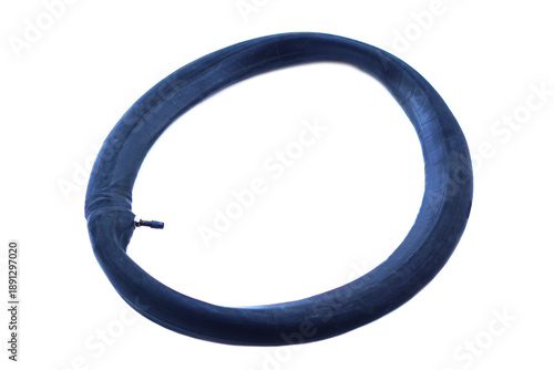 Old used bicycle inner tube made of black rubber isolated on white background with air valve visible. Worn circular bike tube showing aging material, recycling, repair, maintenance and  transportation