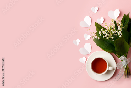 Bouquet of flowers cup of tea, paper hearts on a pink background. Concept of romance holiday, 14 february, Saint Valentine, 8 march, woman day, mother day, copy space