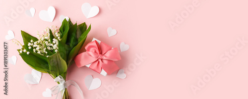Bouquet of flowers and gift box, paper hearts on a pink background. Concept of romance holiday, 14 february, Saint Valentine, 8 march, woman day, mother day, copy space